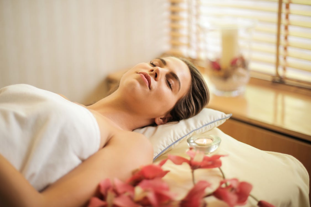 A woman lying on the massage bed feeling relaxed after an Asian therapy massage